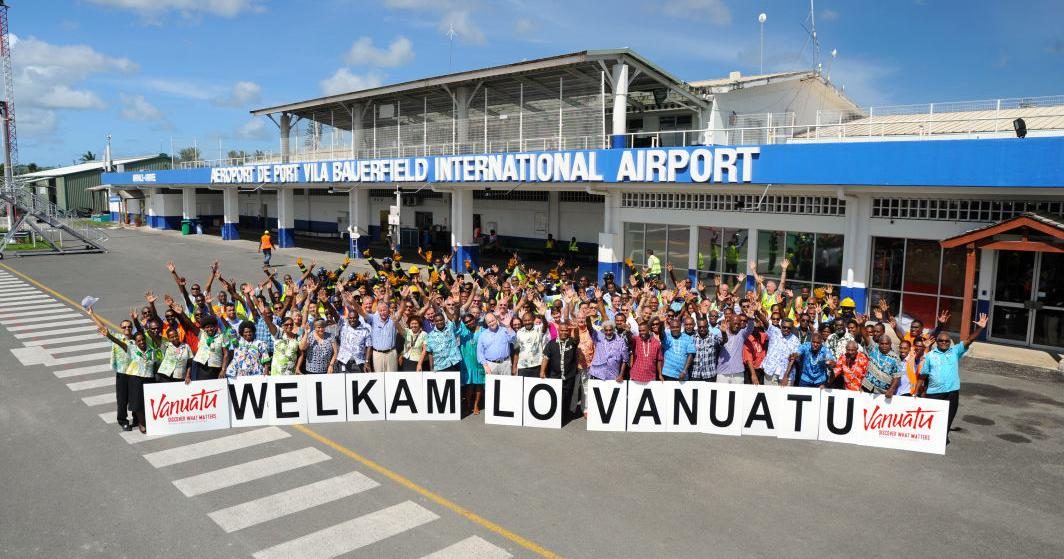 Welcome sign and airport staff at Bauerfield International Airport, Port Vila, Vanuatu